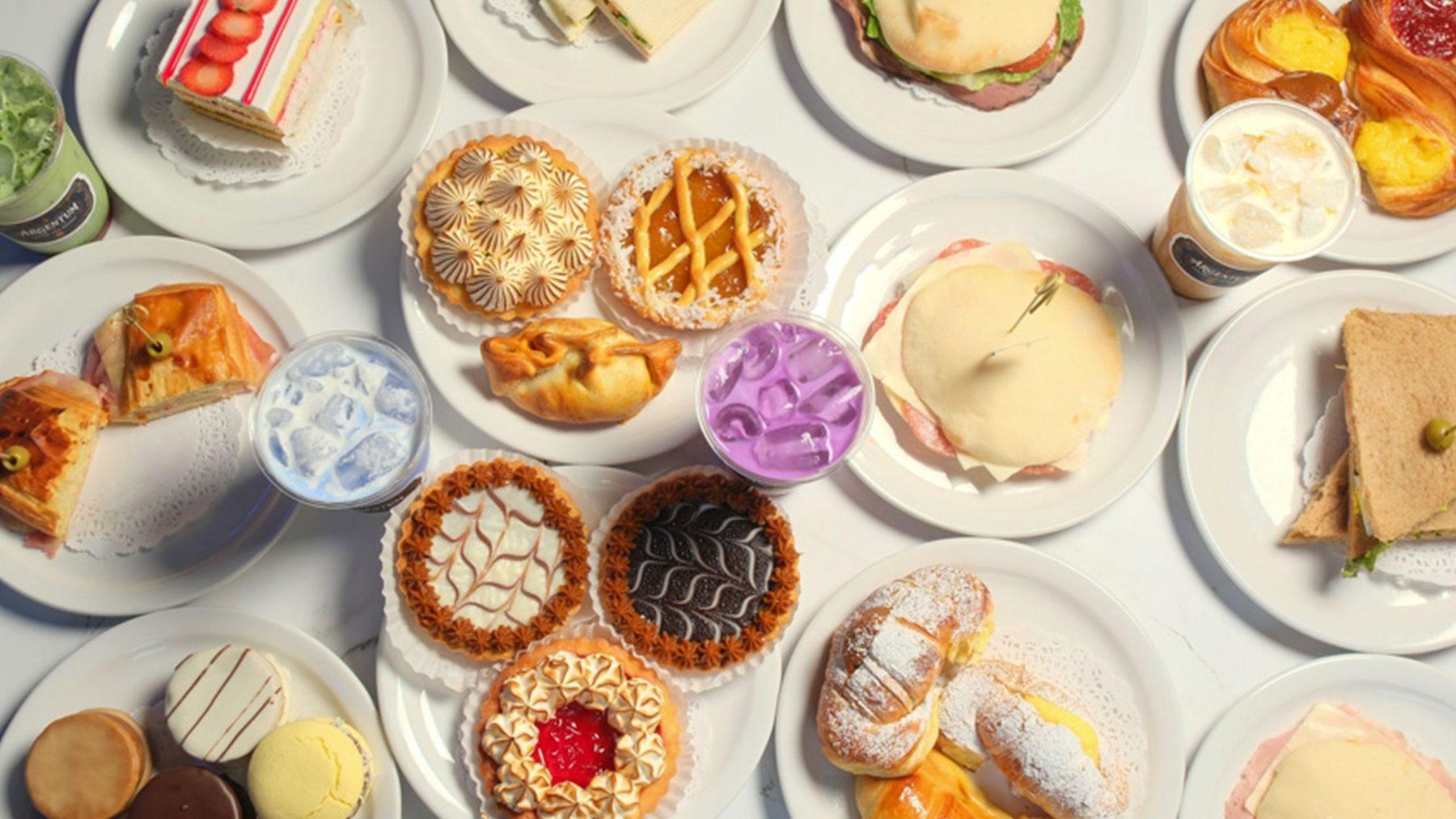 An overhead spread of Argentum pastries, tarts, alfajores and sandwiches
